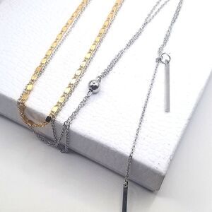 Layered chain pendant necklace gold and silver toned.